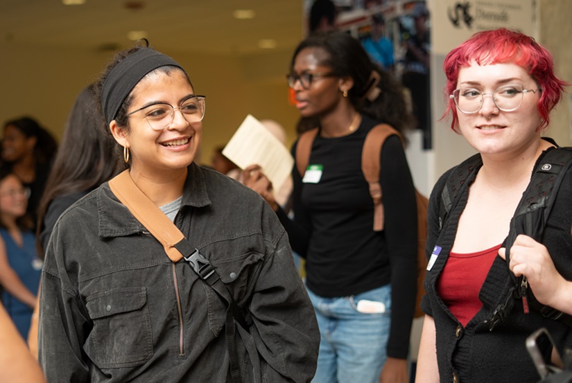 Students share a laugh at an end-of-year gathering in Nesbitt Hall lobby